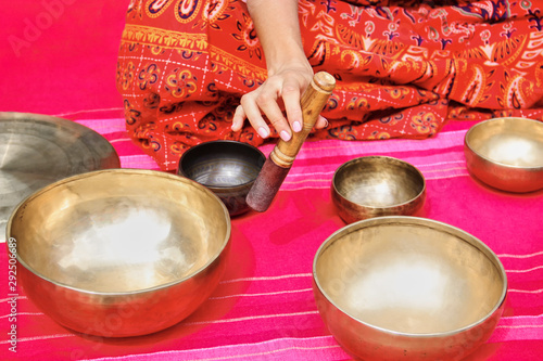 Tibetan singing bowl on the pink background
