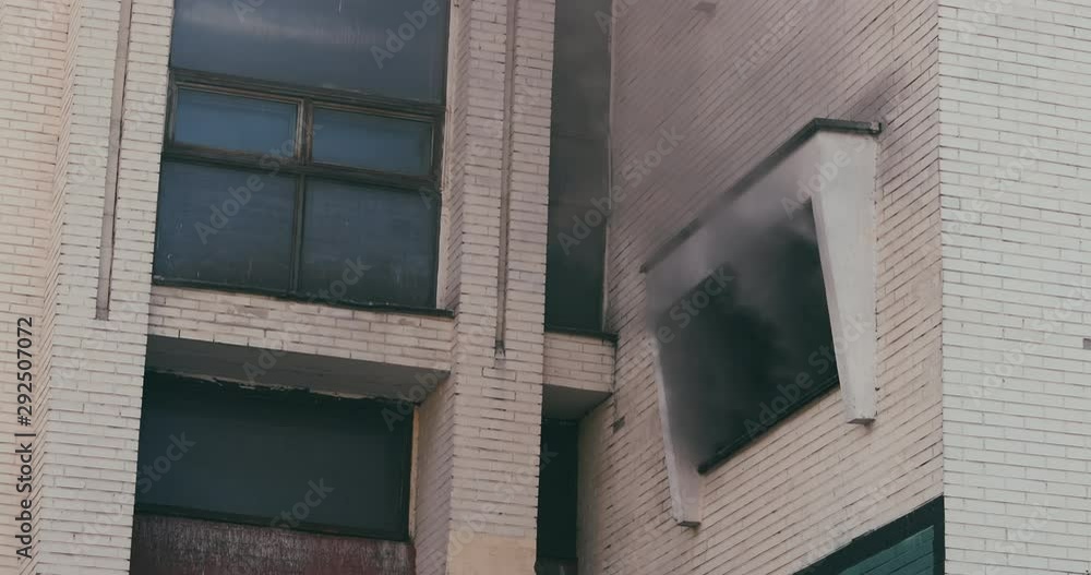 Black smoke from the ventilation grill of an industrial building. Fire ...