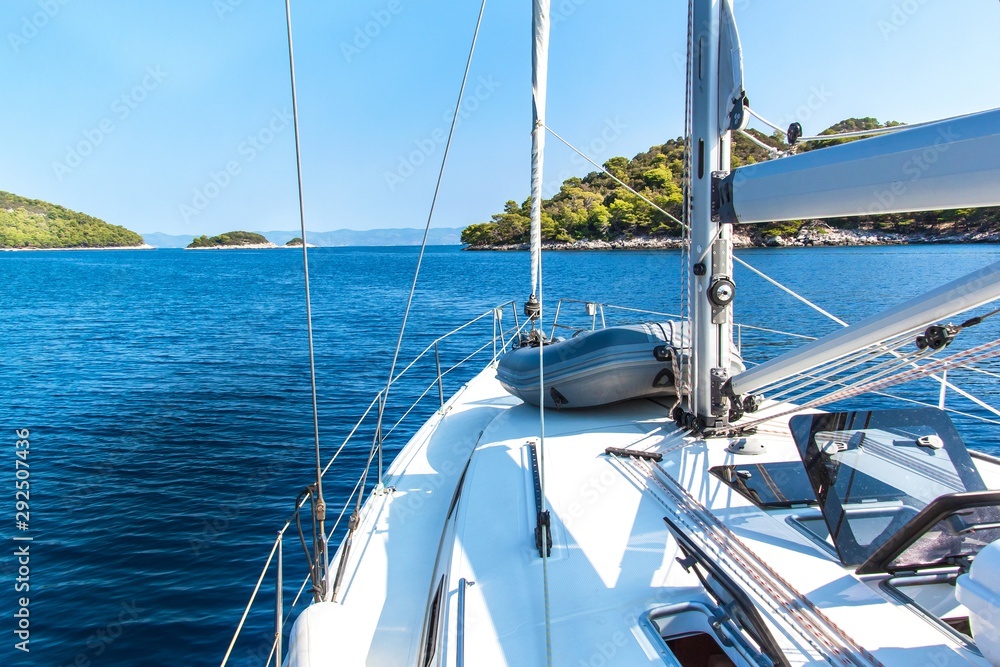 Obraz premium Sailing boat near Croatian island Lastovo. View from the deck of the yacht. Vacation on a boat. Sailing on the sea.