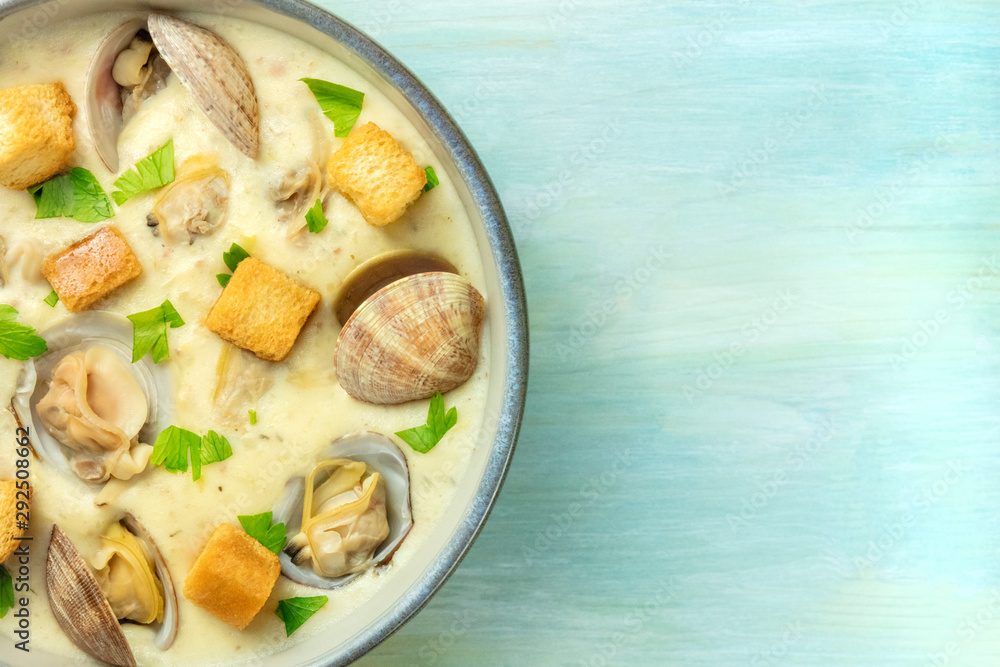 Clam chowder with fresh parsley and croutons, close-up shot from the top with a place for text Clam chowder with fresh parsley and croutons, close-up shot from the top with a place for text