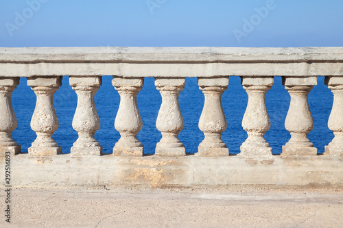 Old stone balustrade with blue sea and sky