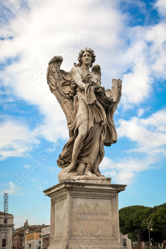 Statue of an angel against the blue sky on the bridge of Sant angelo in Rome  Italy