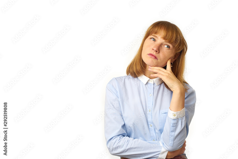 Indoor shot of nice redhead young woman looking sideways, having doubtful and indecisive face expression as if considering some ideas or making serious decision. Indoor shot of nice redhead young woman looking sideways, having doubtful and indecisive face expression as if considering some ideas or making serious decision.