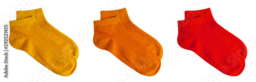 Set of short socks yellow, orange, red isolated on white background with clipping path for winter season. Top view. Pair of trendy woman cotton sock object for clothing. Beauty and fashion concept. photo