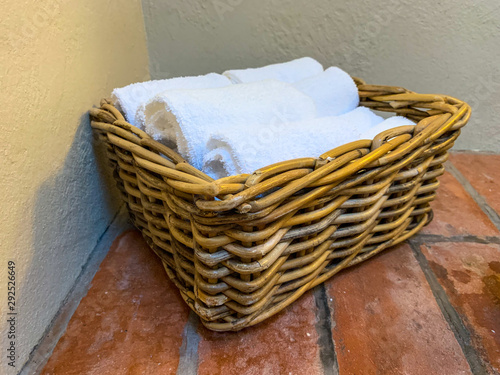 Towels  lined up in a basket and stacked for the walk to the toilet, then handwashed