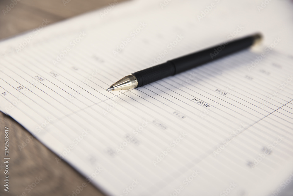 pen on document on desk pen on document on desk