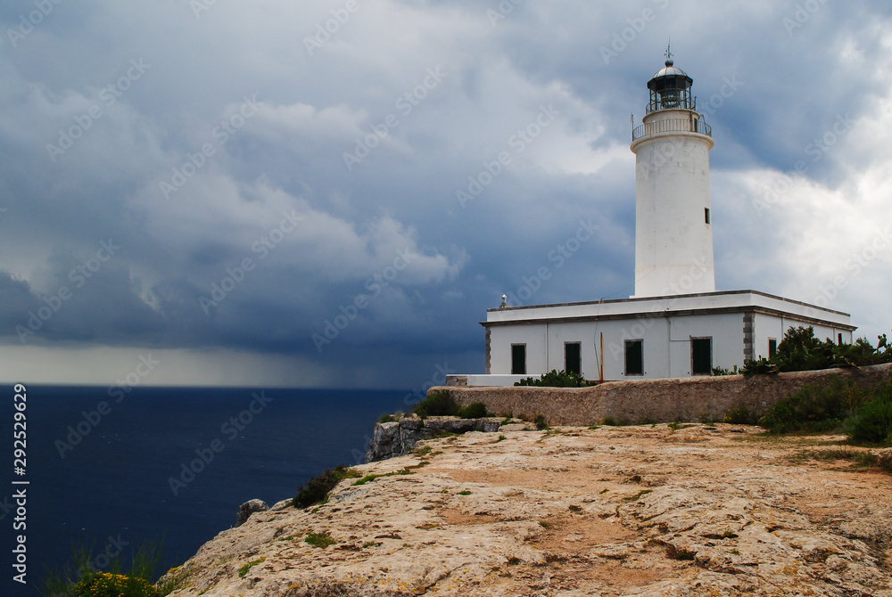 Far de la Mola, lighthouse on the cliffs of Formentera an approaching storm.