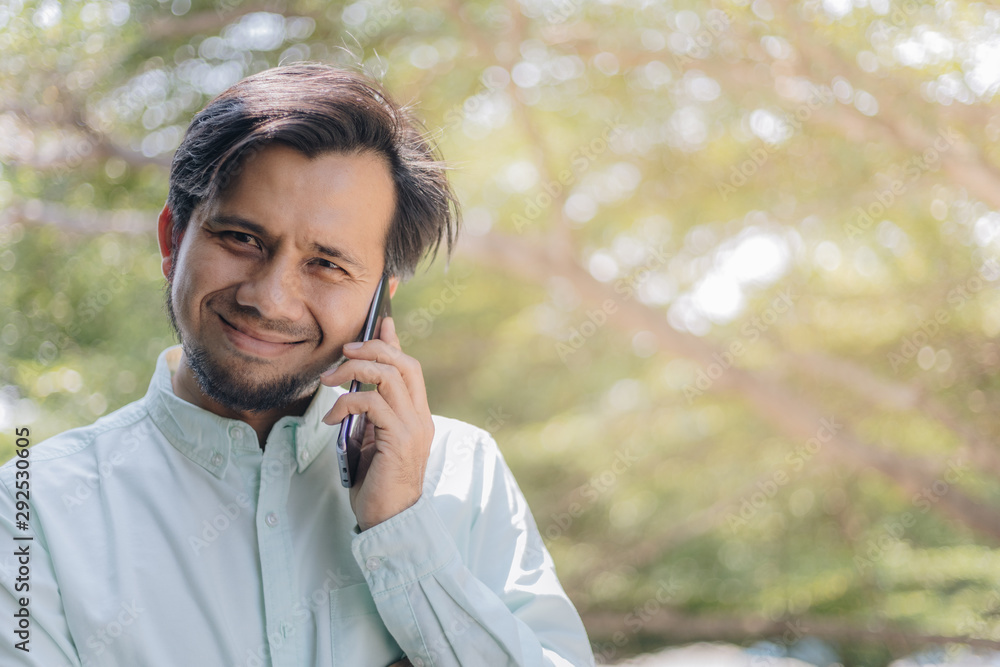 asian man talking on smartphone he and happy asian man talking on smartphone he and happy