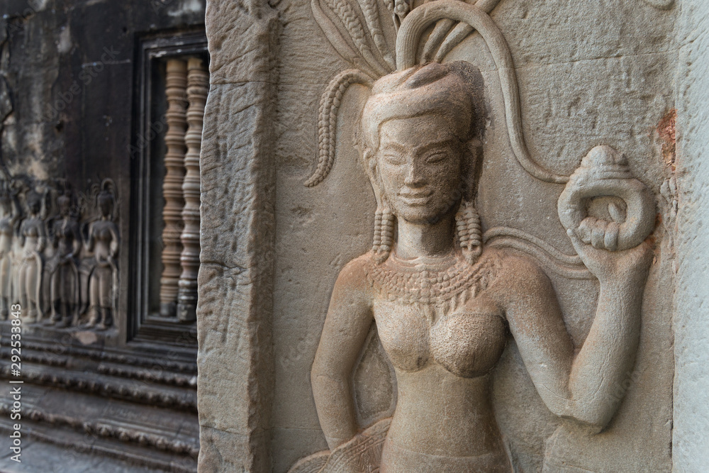 Bas-relief mural of the woman Apsara on wall Angkor Wat temple complex, close up