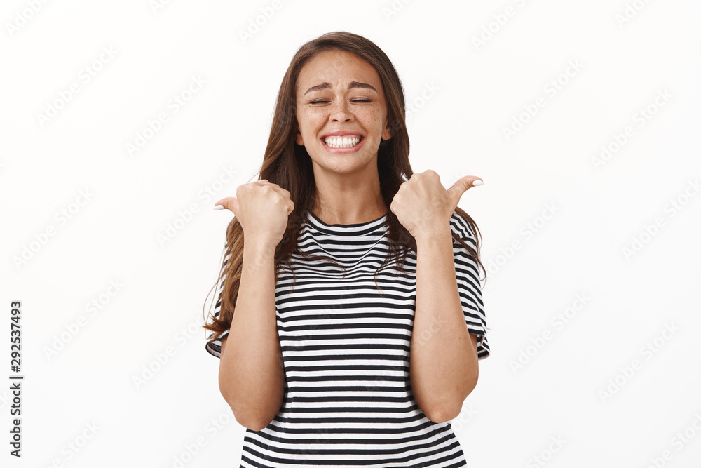 Extremely happy lucky cheerful girl jumping from happiness and surprise, close eyes raise thumbs up and do champion dance, triumphing from receiving award, celebrating victory Extremely happy lucky cheerful girl jumping from happiness and surprise, close eyes raise thumbs up and do champion dance, triumphing from receiving award, celebrating victory