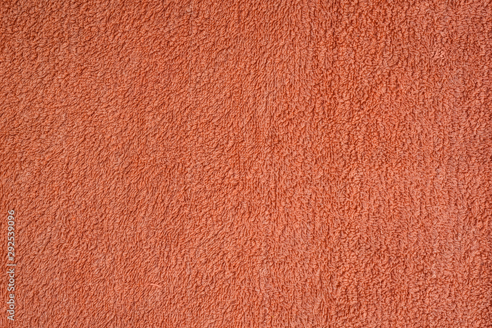 Fototapeta premium Smooth seamless texture of a terry towel. Coral color