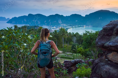 Girl Backpacker admires beautiful landscape of the Ko Phi Phi  after sunset, Thailand