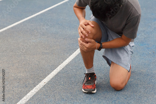 Sport man suffering with pain on sports running knee injury after running.Injury from workout concept.
