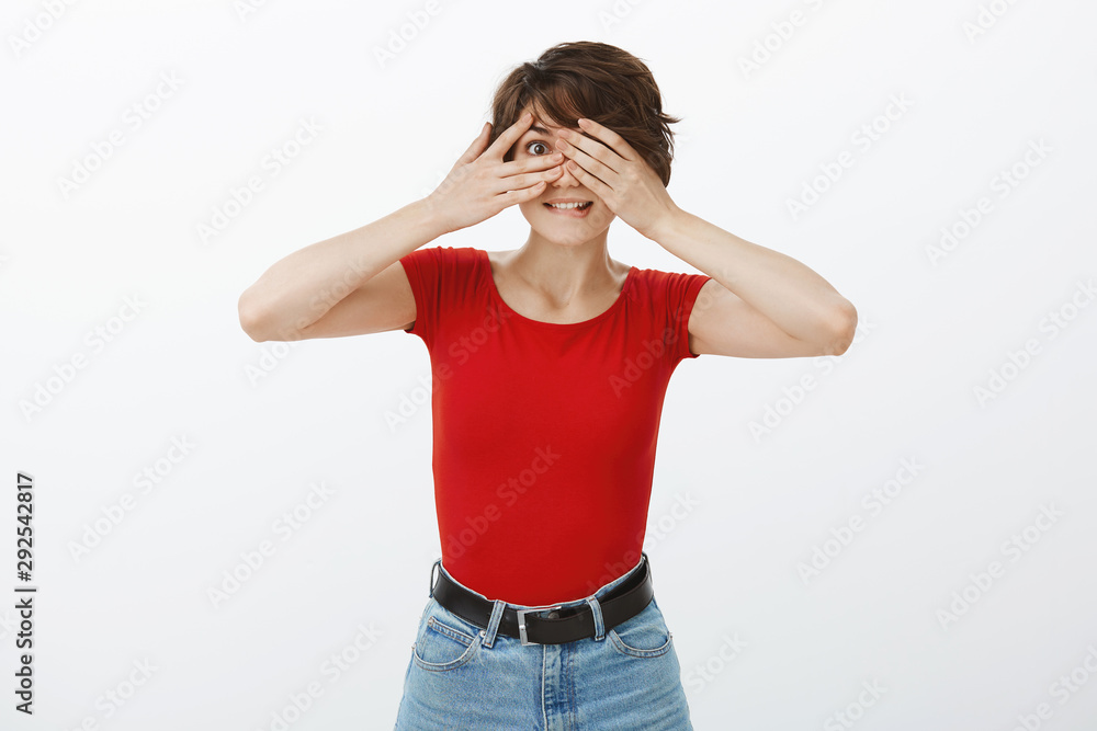 Cheerful intrigued silly tempting female student celebrating b-day close eyes awaiting surprise gift peeking through fingers smiling awkward amused standing white background interested curiously Cheerful intrigued silly tempting female student celebrating b-day close eyes awaiting surprise gift peeking through fingers smiling awkward amused standing white background interested curiously