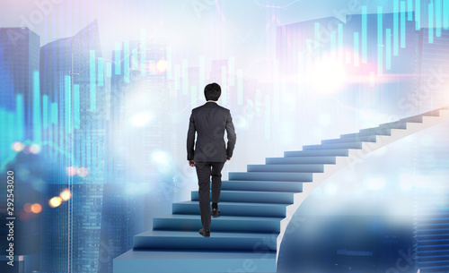 Man walking on stairs in city with graphs photo