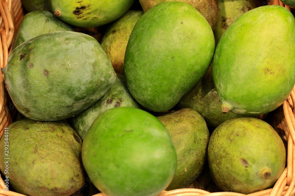 Fresh green mango lying on the counter in the supermarket. Fruit background. Fresh green mango lying on the counter in the supermarket. Fruit background.