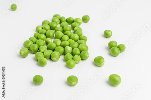Fresh organic green peas isolated on white randomly displayed, side view, with space for text