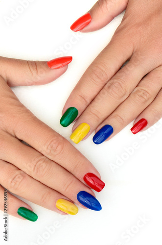 Multicolored bright manicure with different shapes of square  oval  sharp nails on a white background.