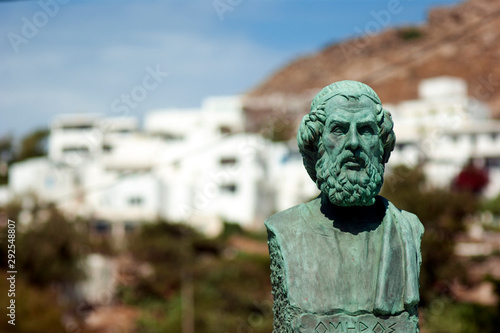 Greece, the island of Ios, the statue of Homer at the islands harbour. Blurred (bokeh) background, copy space.