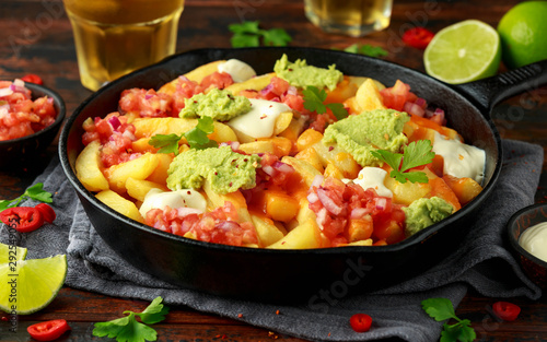 Loaded potato nachos with melted cheddar cheese, sour cream, tomato salsa, chilli, guacamole and beer