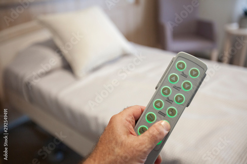 Принти на полотні Adjustable bed remote in hand