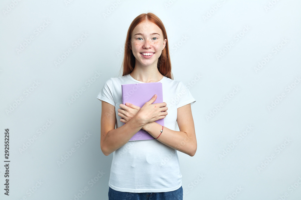 happy student enjoying reading books, she hugging her book, hobby, interest, leisure , close up portrait, isolated white background happy student enjoying reading books, she hugging her book, hobby, interest, leisure , close up portrait, isolated white background