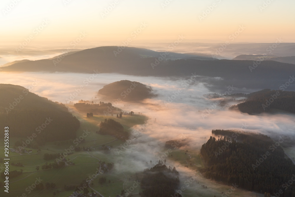 Amazing landscape of the Black Forest in the morning with fog during sunrise, seen from a hot-air ballon, Hinterzarten, Germany