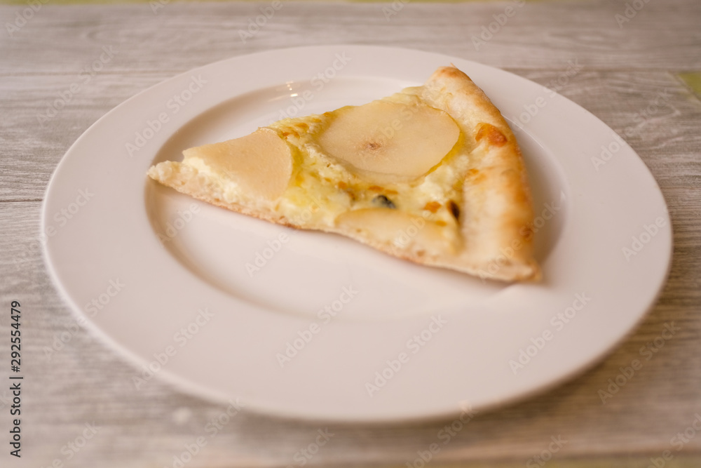Delicious pizza with Round Pear Slices, Roquefort Blue Cheese served at Italian Restaurant with Plate. Traditional Food