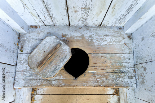 interior of an old wooden outhouse photo