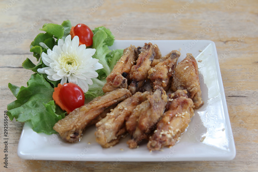 Fried chicken wings with sesame seeds on white plate. Fried chicken wings with sesame seeds on white plate.