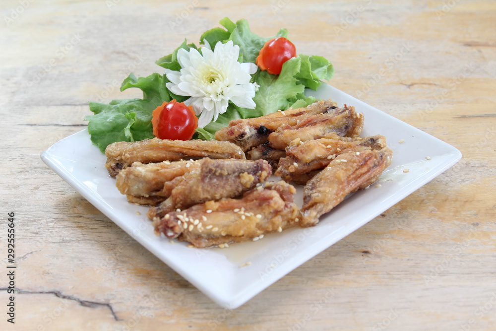 Fried chicken wings with sesame seeds on white plate. Fried chicken wings with sesame seeds on white plate.