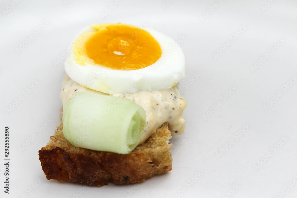 Sandwich with bread, salad dressing and boiled egg on white background. Sandwich with bread, salad dressing and boiled egg on white background.