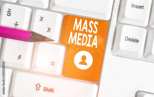 Conceptual hand writing showing Mass Media. Concept meaning Group showing making news to the public of what is happening White pc keyboard with note paper above the white background photo