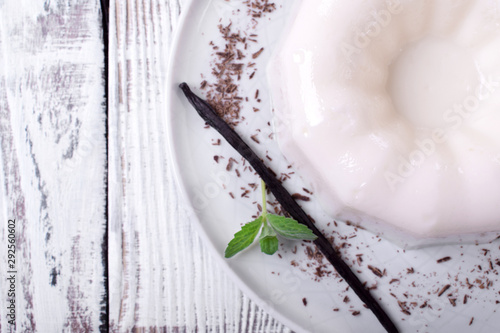 White vanilla milk jelly on ceramic plate on white wooden table