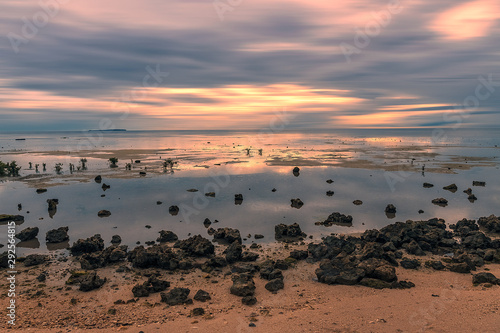 sunset long exposure in the beach with rocks