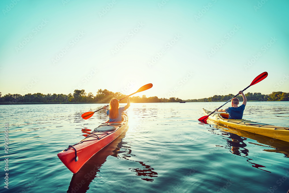 © 6okean - People kayak during sunset in the background. Have fun in your free time. © 6okean - People kayak during sunset in the background. Have fun in your free time.