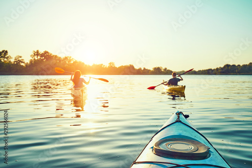People kayak during sunset in the background. Have fun in your free time. © 6okean