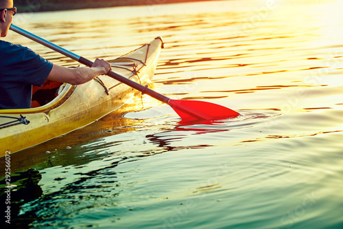 People kayak during sunset in the background. Have fun in your free time. #292566072