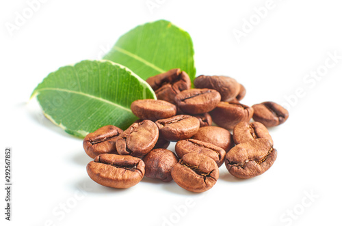 Coffee beans and leaves isolated on white background, closeup.