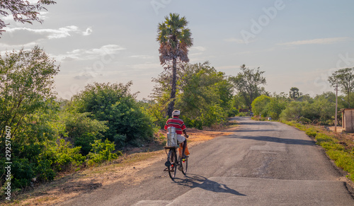Tableau sur toile Village Milk Man carrying container full of milk in bicycle at Evening - Tamilna