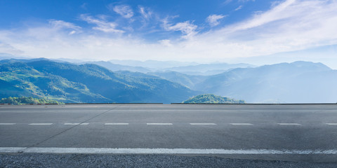 Empty highway asphalt road and beautiful sky mountain landscape