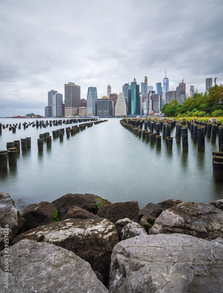 Manhattan skyline with an old pier in the foreground. View of downtown Manhattan at sunset from Brooklyn Bridge Park Manhattan skyline with an old pier in the foreground. View of downtown Manhattan at sunset from Brooklyn Bridge Park
