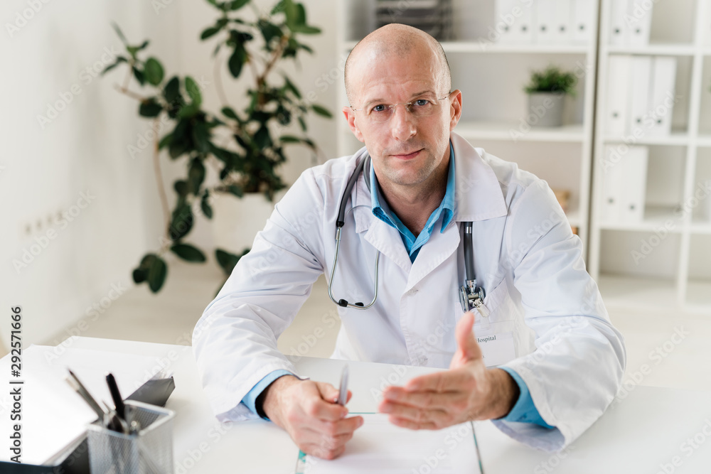 Confident practitioner with stethoscope and pen giving you medical advice Confident practitioner with stethoscope and pen giving you medical advice
