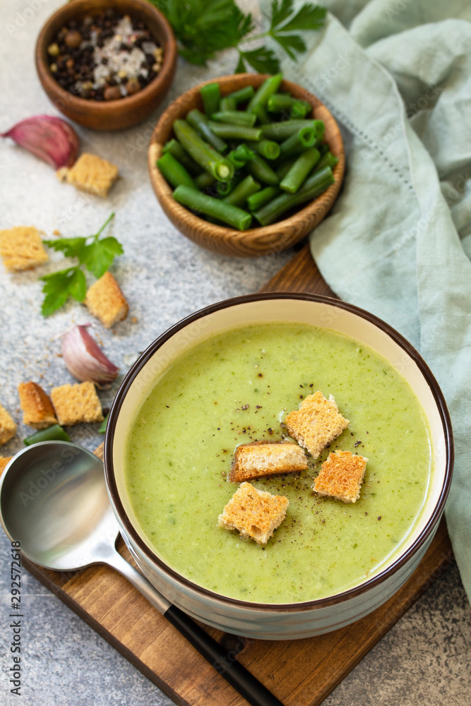 Vegetarian dish. Dietary delicious cream soup of green beans on a light background. Vegetarian dish. Dietary delicious cream soup of green beans on a light background.