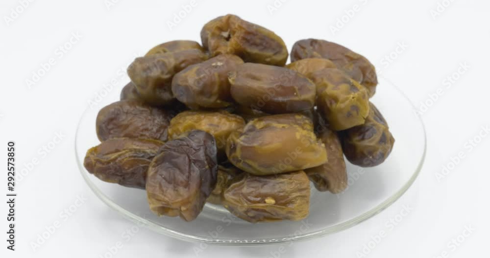Dry date palm fruits rotation on white background, healthy food concept. Dry date palm fruits rotation on white background, healthy food concept.