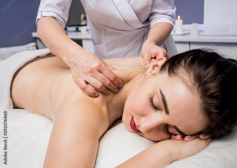 Beautiful young woman enjoying massage in spa salon. Cosmetology Beautiful young woman enjoying massage in spa salon. Cosmetology