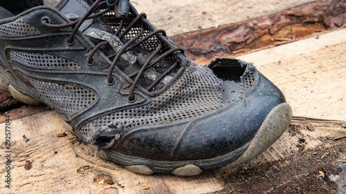 Photos torn old shoes on the background of boards
