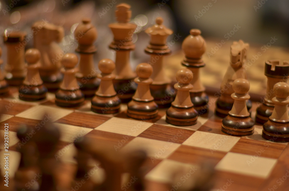 Closeup of a wooden Chessboard. Chess is a two-player strategy board game played on a checkered board with 64 squares arranged in an 8×8 grid, believed to be derived from the Indian game Chaturanga. Closeup of a wooden Chessboard. Chess is a two-player strategy board game played on a checkered board with 64 squares arranged in an 8×8 grid, believed to be derived from the Indian game Chaturanga.