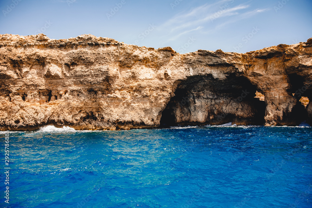 Panorama beach Blue Lagoon Comino Malta. Rocky coast with window and arch Mediterranean Sea