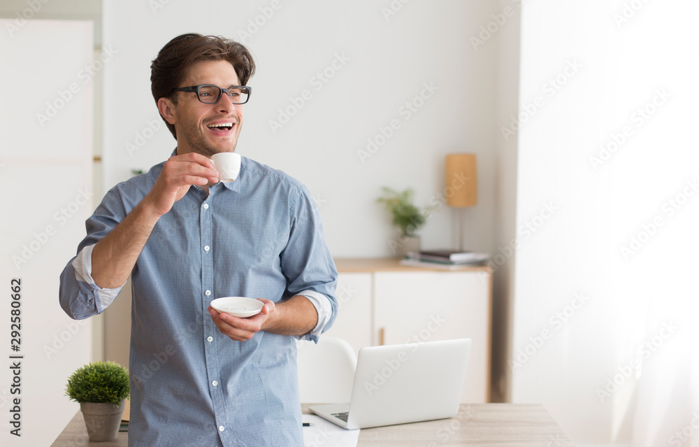 Happy Guy Drinking Coffee Standing In Home Office Happy Guy Drinking Coffee Standing In Home Office